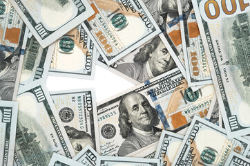 A creative photo of U.S. one-hundred-dollar bills forming an arrow pointing to the right with negative space in the center. The concept of financial progress, investment potential, strategic planning.