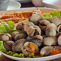 Boiled cockles with seafood dipping sauce