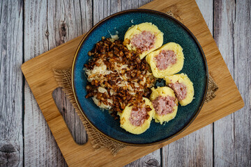 Traditional Czech Dish with Potato Dumplings, Smoked Meat, Sauerkraut, and Fried Onions