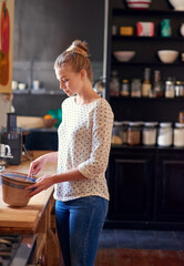 Kitchen, woman and baking preparation in home with mixing ingredients for bread recipe, cake or dessert. Baker, person and bowl to whisk batter for cookies, muffins snack and culinary skills in house