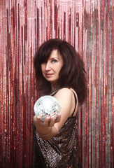 Young pretty woman with a shining disco ball