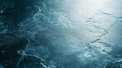 Fototapeta premium A dark stone surface showcases unique textures and patterns under soft lighting, creating a serene atmosphere