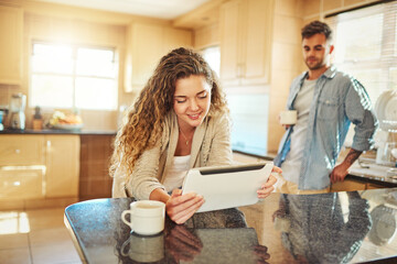 Woman, home and tablet at kitchen counter with smile for social media, post and networking. People, couple and happiness at apartment on internet in morning with subscription and app download