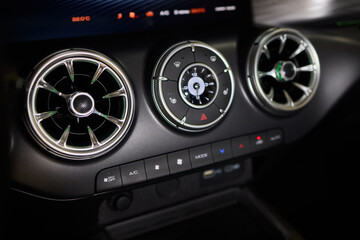 Closeup of car dashboard air vents near gear shift