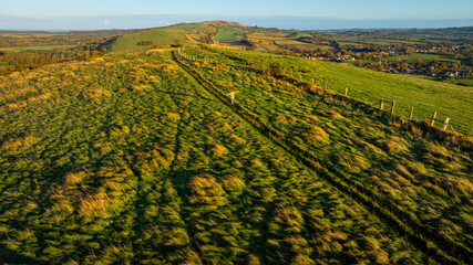 Aerial sunset view of Corfe Castle, a village and civil parish in the English county of Dorset