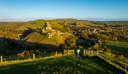 Fototapeta premium Aerial sunset view of Corfe Castle, a village and civil parish in the English county of Dorset
