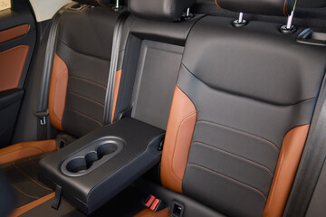 Obraz premium Vehicle armrest with cup holder, beige design, for luxury cars