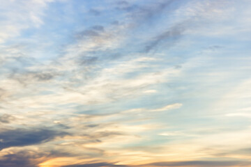 A beautiful sky tinted by the sun leaving vibrant shades of gold, pink, blue and multicolored. Clouds in the twilight evening and morning sky. Cloudy sky background in the evening, and during the day.