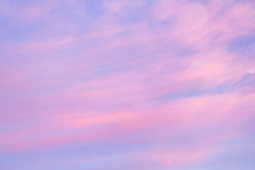 A beautiful sky tinted by the sun leaving vibrant shades of gold, pink, blue and multicolored. Clouds in the twilight evening and morning sky. Cloudy sky background in the evening, and during the day.