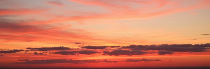 Obraz premium Vibrant red and orange sunset over a wide sky with a multitude of shades of colors, sunrise, peaceful