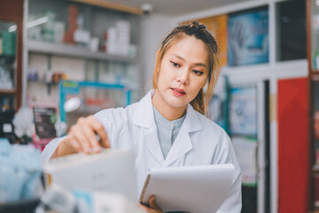 Pharmacist checking Checks Inventory of Medicine, Drugs, Vitamins with tablet and checking patient's prescription in modern pharmacy.