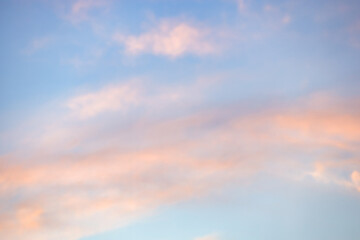 A beautiful sky tinted by the sun leaving vibrant shades of gold, pink, blue and multicolored. Clouds in the twilight evening and morning sky. Cloudy sky background in the evening, and during the day.