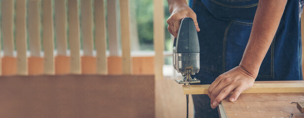 Banner DIY craftsperson asian man working wood heap carpenter objects woodwork desk. Banner...