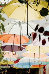 a group of umbrellas of different colors hanging on