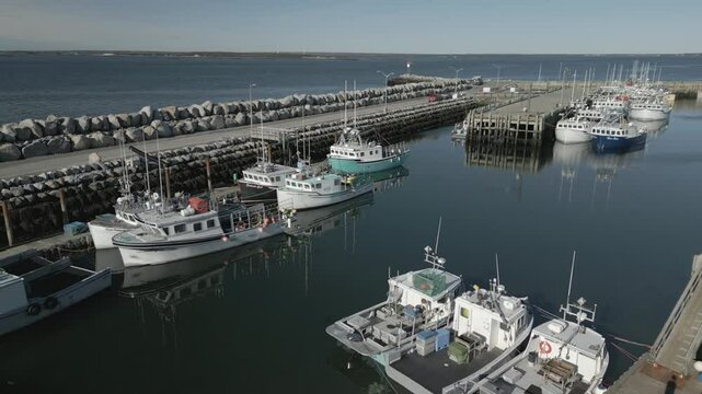 Commercial lobster fishing vessels abound in this aerial view of picturesque Lockeport harbour, Lockeport, Nova Scotia, Canada.  MAX QUAL PRORES422HQ Transcode of 4K H.265 D-CINELIKE original capture.
