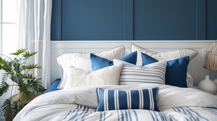 Step into this beach house bedroom and feel instantly transported to a tranquil seaside escape with its cool blue walls crisp white linens and pops of navy in the cabana stripe throw