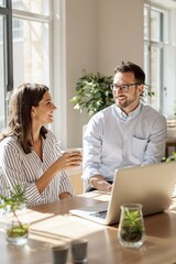 Professional Young Couple Collaborating in a Bright Modern Office Space