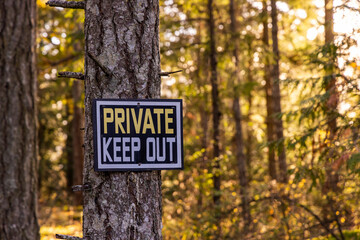Private Keep Out Sign in Sunlit Forest Scene