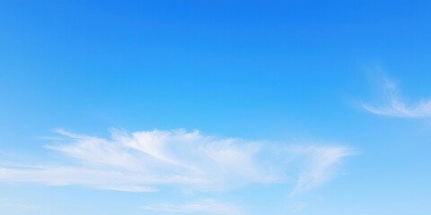 Fototapeta premium A tranquil blue sky with a few wispy stratus clouds stretching across the horizon, layered, cloud formations