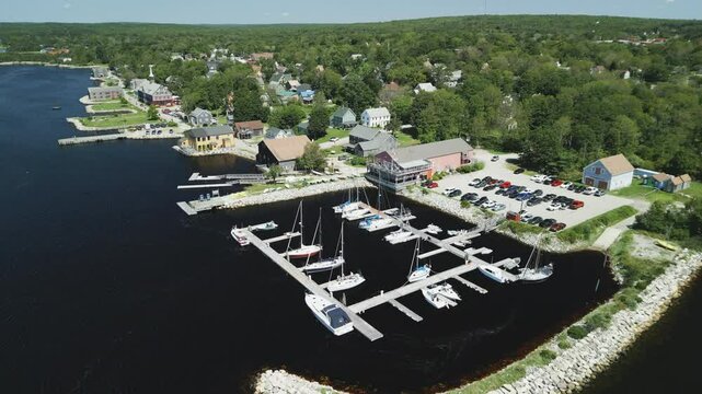 Aerial view of Atlantic Canada's historic Shelburne harbour waterfront, buildings, Yacht Club & Marina, Nova Scotia, Canada.  MAX QUAL PRORES422HQ Transcode of 4K H.265 D-CINELIKE original capture.