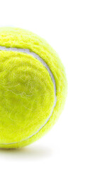 Bright yellow tennis ball with fuzzy surface and white curved seam isolated on white