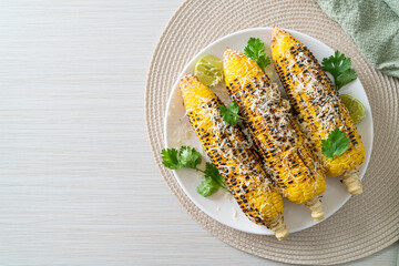 barbecue and grilled corn with cheese and lime