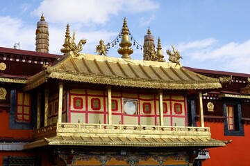 Golden rooftop architectural details of the Jokhang Temple, Lhasa, Tibet, showcasing intricate...