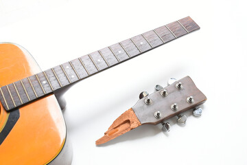 part of broken wood acoustic guitar isolated on white background