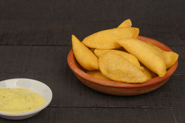 Delicious traditional Colombian empanadas with spicy sauce