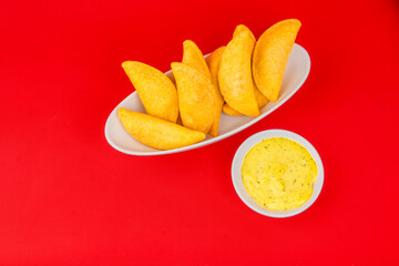 Delicious traditional Colombian empanadas with spicy sauce