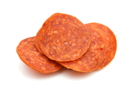 Slices of pepperoni on white background