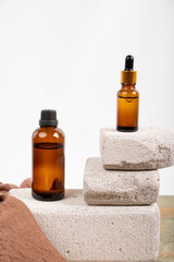 Amber Glass Bottles on Textured Stone Blocks with Minimalist Style