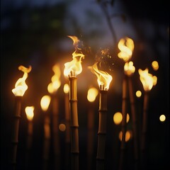 Row of bamboo Torches flaming at night