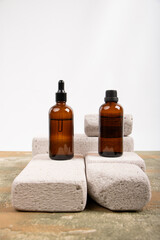 Amber Glass Bottles with Dropper and Screw Caps Displayed on Concrete Blocks