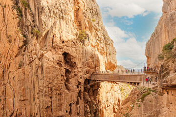 Hikers crossing the bridge of the Caminito del Rey gorge