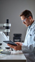 A researcher using experimental equipment while looking at a tablet isolated with white highlights, png