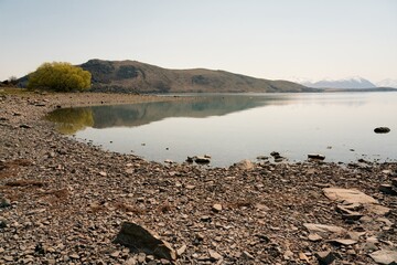 Rocky Shoreline of Lake Tekapo: Scenic New Zealand Landscape