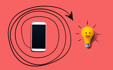 Creativity, inspiration, idea concept with light bulb and smartphone - Flat lay