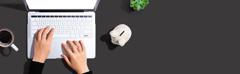 Laptop computer with piggy bank - flat lay