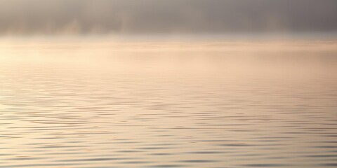 A delicate web of light dances across the rippled waters as morning fog settles, soft light, beach scene