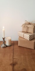 A wooden table adorned with a flickering candle and a stack of beautifully wrapped gift boxes, seasonal, warm, table