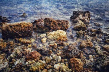 The coastline rocky with gentle waves crashing against the rocks.