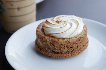 A Truly Delicious Dessert Adorned with a Light and Fluffy Meringue Topping on a White Plate