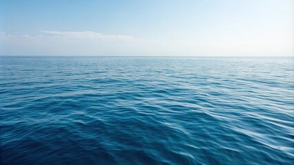 Obraz premium Calm sea surface with gentle ripples on blue ocean waters, vast expanse, reflective surface, soothing hue, oceanic backdrop