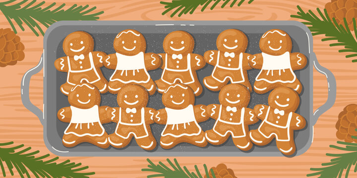 A baking tray with hot gingerbread cookies on the table, surrounded by fir branches and pinecones.