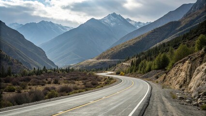 Fototapeta premium Mountainous road winding through empty asphalt, open road, winding road, rural scenery, desolate landscape, serenity