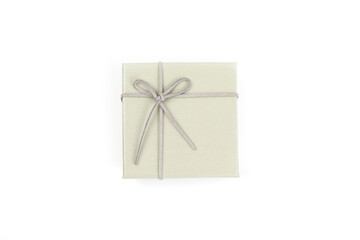Top view, grey gift box tied with a bow isolated on white background. Gift box concept for a happy birthday, thank you, congratulation, mother's day, anniversary, Valentine's Day, or other holidays..