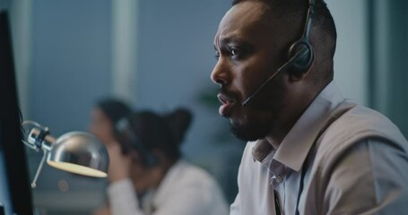 Call center office of emotional support line: Portrait of African American hotline specialist in headset consulting person on call, providing psychological help. Online mental health helpline operator