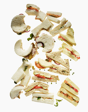 Half-Eaten and Nibbled Tea Sandwiches on a White Background