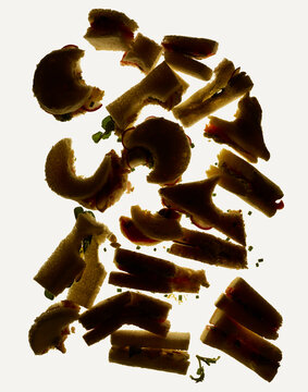 Half-Eaten Tea Sandwiches in Silhouette on a Light Background